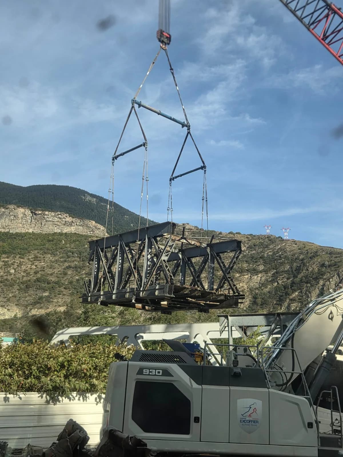 Élément métallique levé par une grue sur le chantier